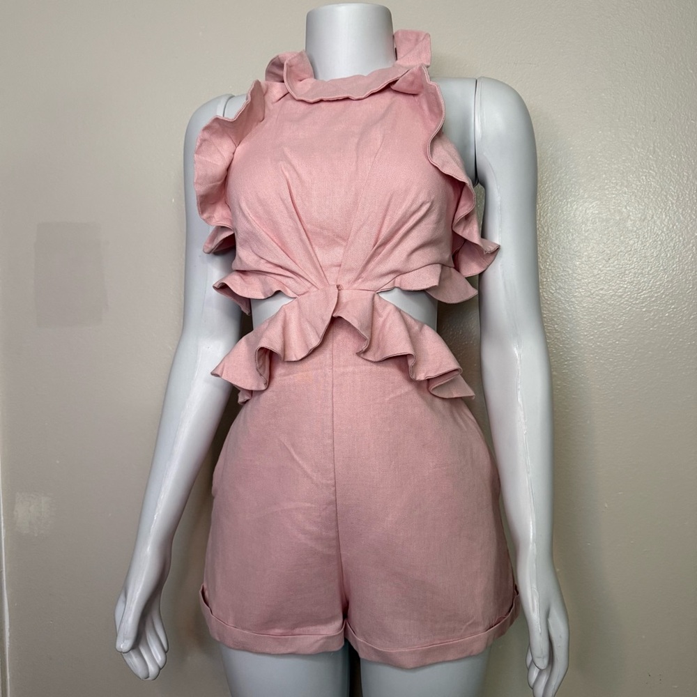 Pink halter neck cutout romper with ruffle details